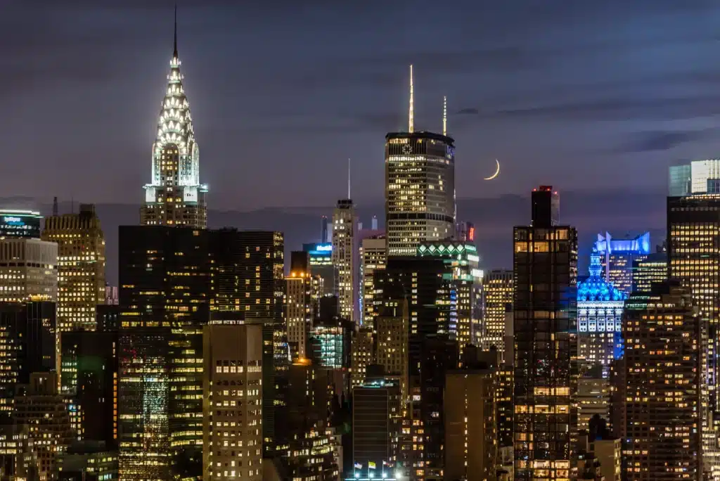 The crescent moon in the background over the midtown Manhattan skyline in New York City, NY