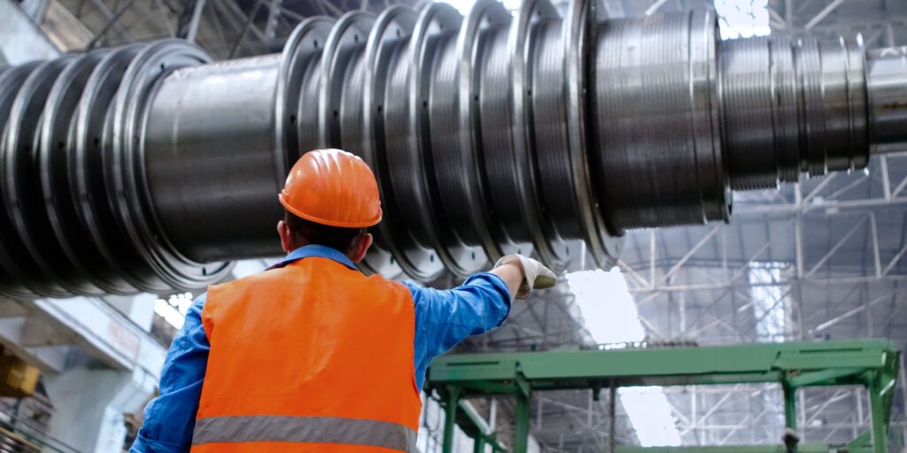 Power plant worker supervising operations without wearing protective equipment to prevent potential asbestos exposure