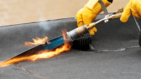 Construction Worker Cutting Asbestos Roofing Felt