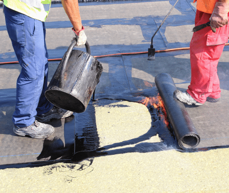 Roof Workers Laying Asbestos Felt