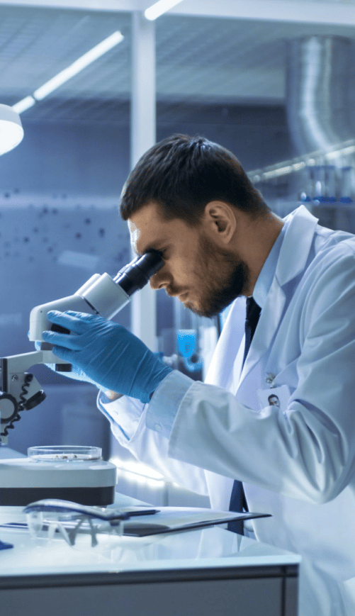 Doctor looking through a microscope