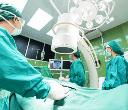 External beam radiation therapy during surgery with 3 doctors and patient in operating room