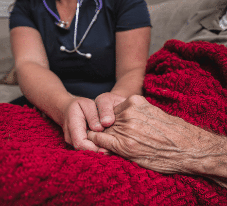 Caregiver Supportively Holding the Hand of a Mesothelioma Patient
