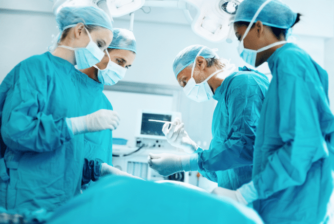Four surgeons in an operating room