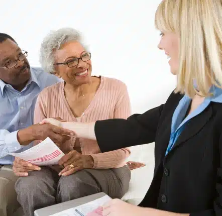Woman shaking hands with an elderly couple