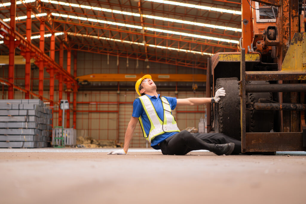 Young man working in a steel industry factory. He was critically hurt when a forklift ran over his leg, crushed it, and had to be transported to the hospital.