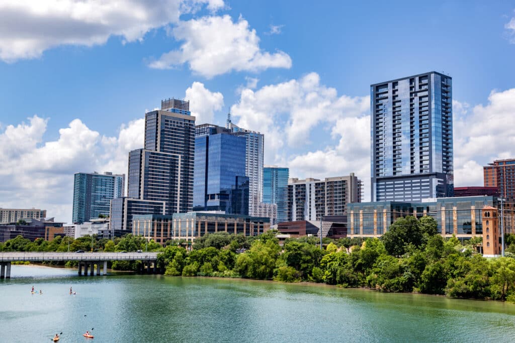 Downtown skyline of Austin, Texas, the USA. Colorado River and skyscrapers on blue sky