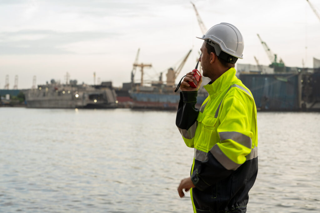 Marine engineer communicating via walkie-talkie