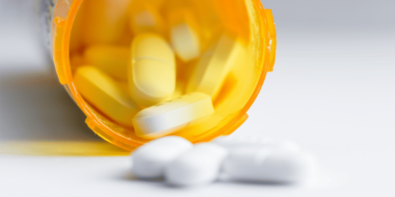 Pills pouring from pharmacy bottle