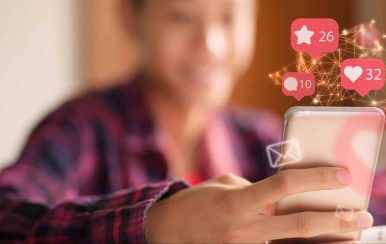 Kid holding a phone addicted to the amount of likes and comments from social media that pop-up from his phone